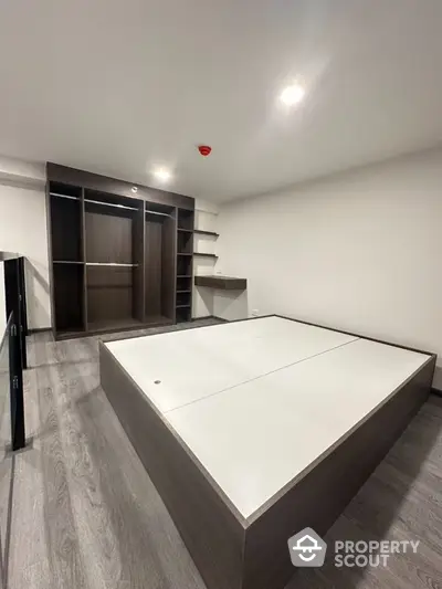 Modern bedroom with built-in wardrobe and sleek flooring