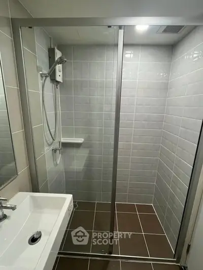 Modern bathroom with sleek shower enclosure and stylish tiles.