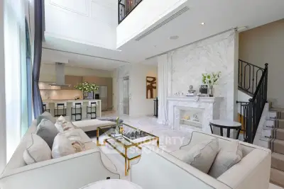 Luxurious open-plan living room with elegant decor and modern kitchen