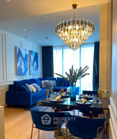 Luxurious living room with elegant chandelier and stylish blue decor