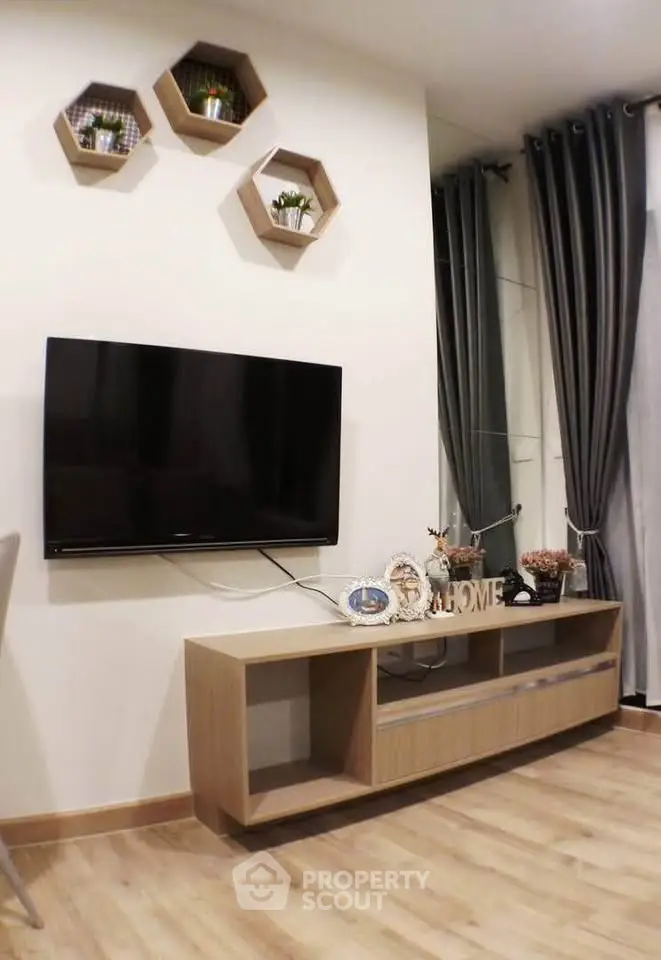 Modern living room with wall-mounted TV and stylish decor