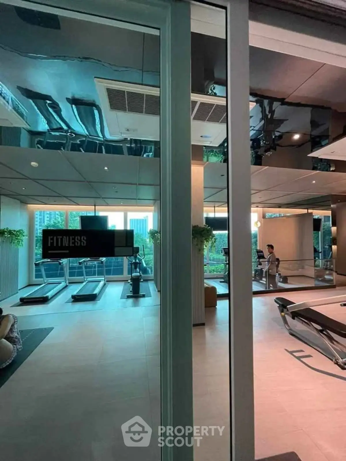 Modern gym with city view and state-of-the-art fitness equipment
