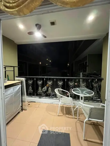 Charming balcony with elegant railing and cozy seating area, perfect for relaxing evenings.
