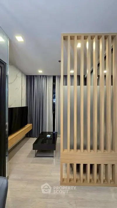 Modern living room with stylish wooden partition and sleek furniture design.