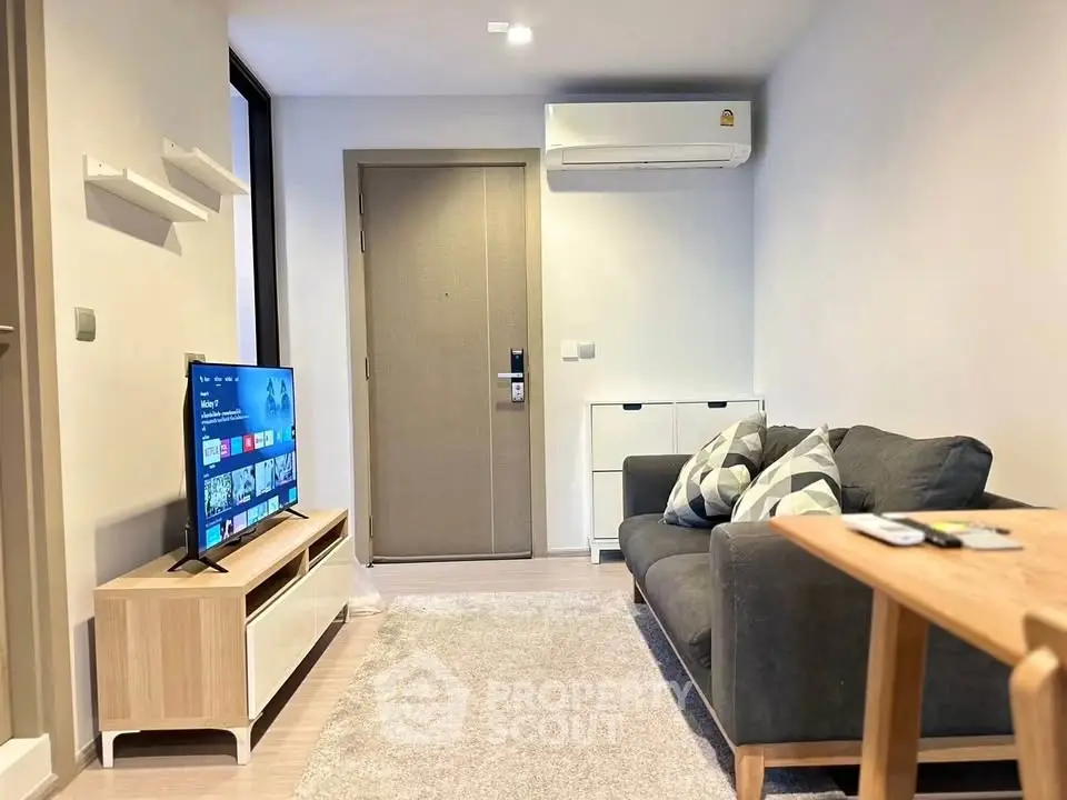 Modern living room with sleek furniture and wall-mounted TV, perfect for cozy urban living.