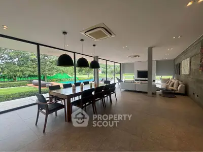 Spacious modern living room with large windows and garden view