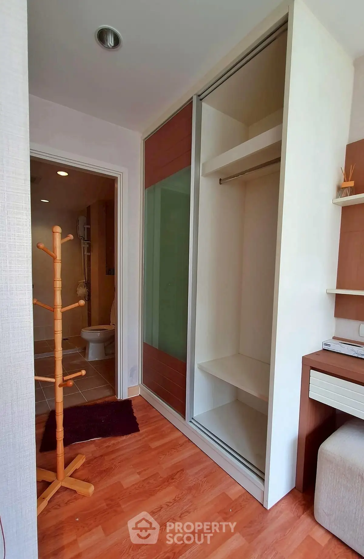 Modern bedroom with sliding closet and wooden flooring