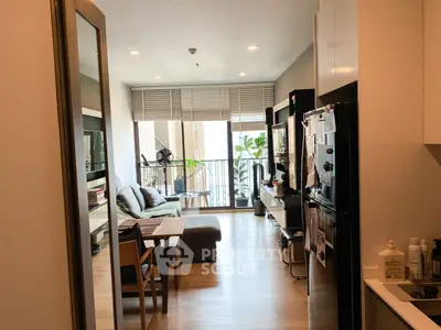 Modern living room with open layout and balcony view, featuring stylish furniture and natural light.