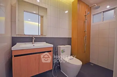 Modern bathroom with sleek fixtures and spacious shower area.