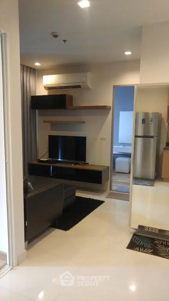 Modern living room with sleek furniture and air conditioning in a stylish apartment.