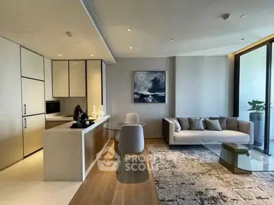 Modern open-plan living room with sleek kitchen and stylish decor in luxury apartment.