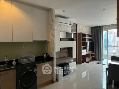 Modern apartment interior with open kitchen and living area, featuring sleek design and city view balcony.