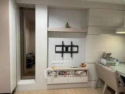 Modern living room with TV mount and dining area, featuring sleek storage and contemporary decor.