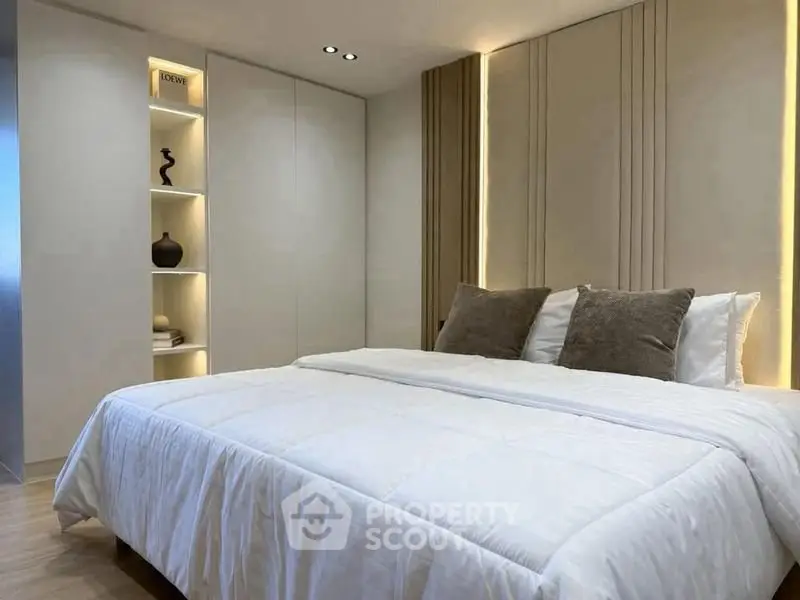 Luxurious modern bedroom with elegant lighting and plush bedding
