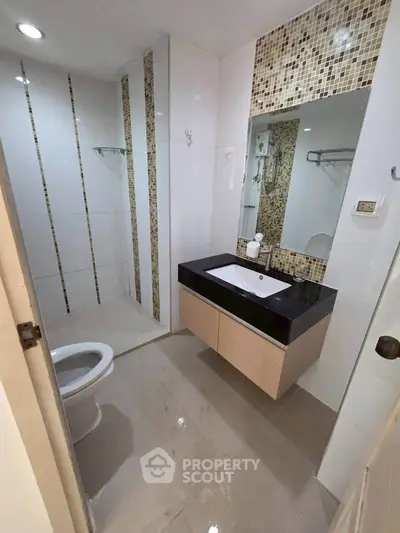 Modern bathroom with sleek fixtures and stylish tile accents in a contemporary home.