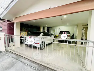 Spacious covered parking area with two cars in a residential property