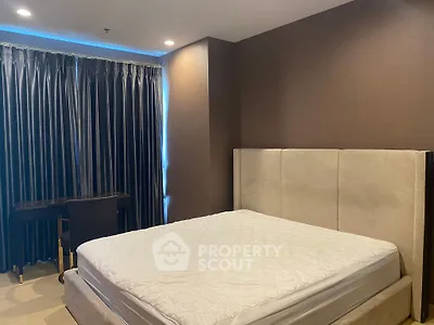 Luxurious bedroom with elegant decor and plush bedding in a modern apartment.