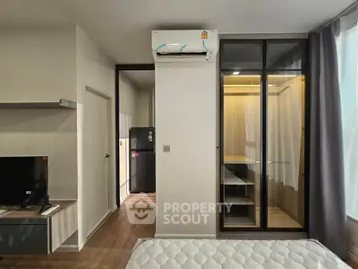 Modern bedroom with sleek design, featuring built-in wardrobe and air conditioning for ultimate comfort.