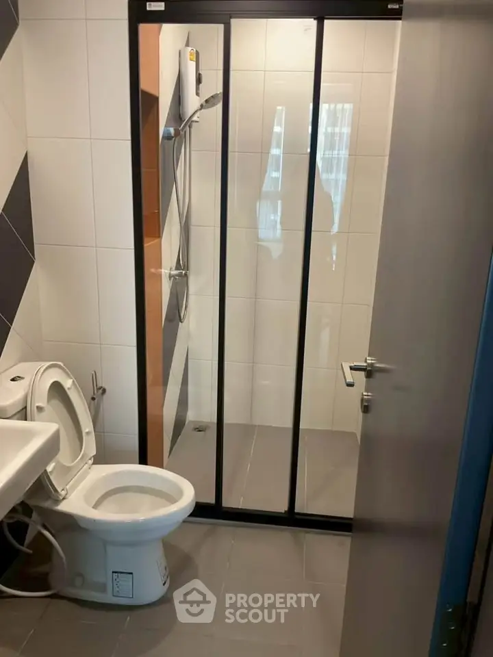 Modern bathroom with sleek shower enclosure and contemporary fixtures.