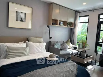 Modern bedroom with cozy seating area and stylish decor