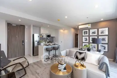 Modern open-plan living room with stylish decor and kitchen area