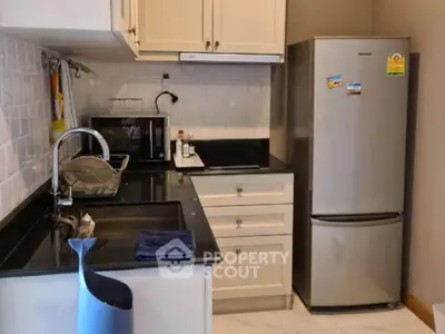 Modern kitchen with sleek appliances and stylish cabinetry, perfect for culinary enthusiasts.