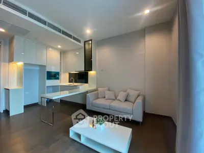 Modern living room with sleek kitchen and cozy sofa in open layout apartment