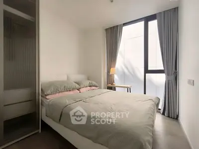 Modern minimalist bedroom with large window and stylish decor
