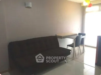 Cozy living room with modern sofa and dining area in bright apartment