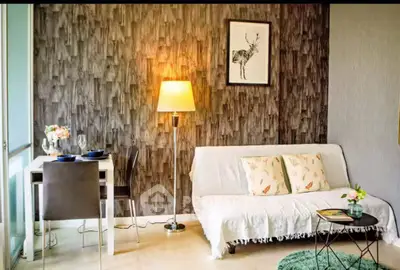 Chic living room with stylish decor, cozy sofa, and elegant dining area perfect for modern living.