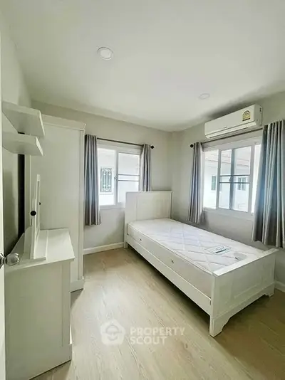 Bright and cozy bedroom with modern furnishings and natural light