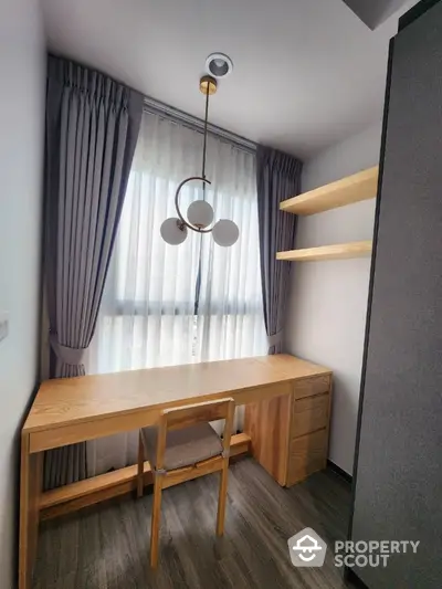 Modern study room with elegant wooden desk and shelves, featuring stylish lighting and floor-to-ceiling curtains.