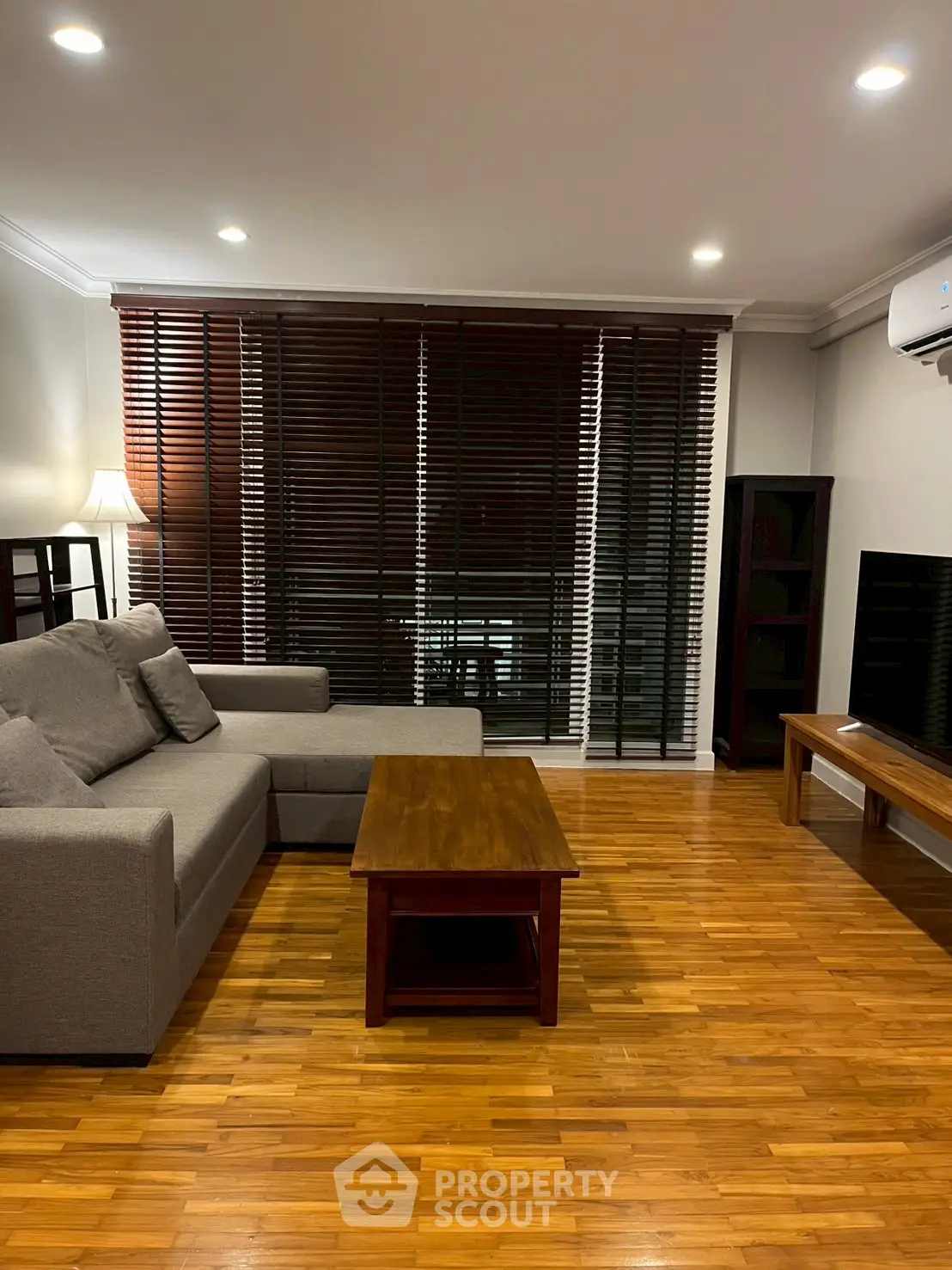 Modern living room with wooden flooring and stylish furniture