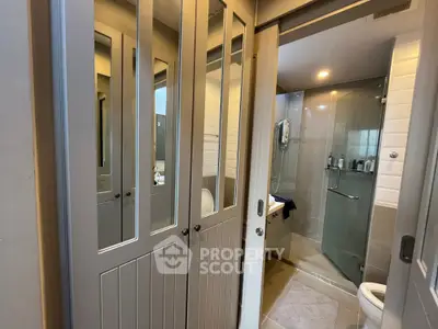 Modern bathroom with glass shower and mirrored sliding doors