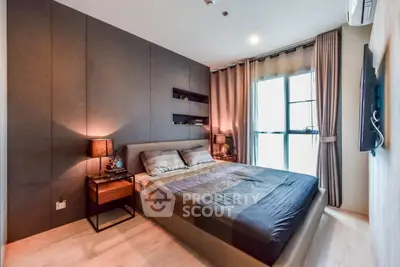 Modern bedroom with stylish decor and large window offering natural light
