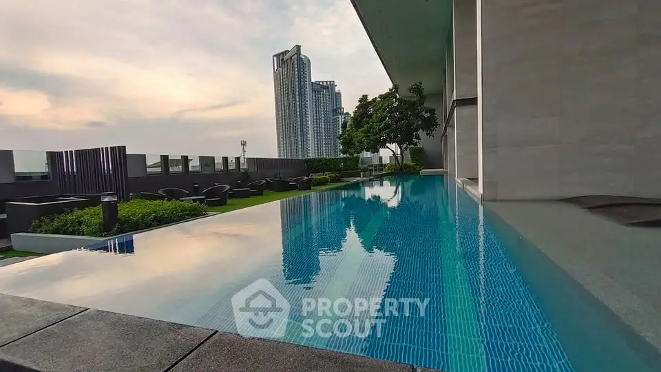 Luxurious rooftop infinity pool with stunning city skyline views and modern outdoor seating area.