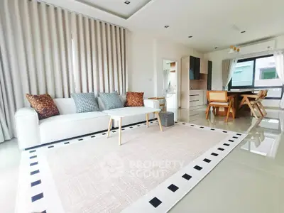 Spacious modern living room with elegant decor and open kitchen layout