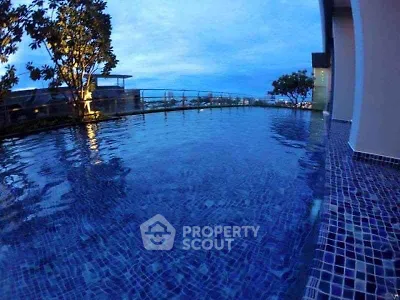 Luxurious rooftop pool with stunning city view at sunset