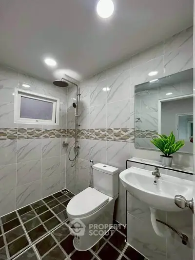 Modern bathroom with elegant tile design and sleek fixtures
