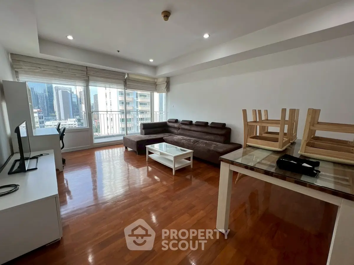 Spacious living room with city view and modern furnishings