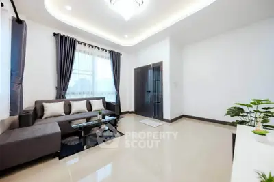 Elegant living room with modern decor and large windows