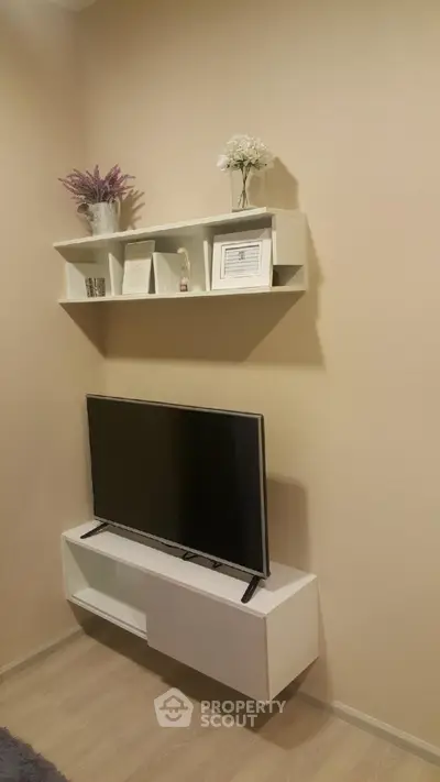 Modern living room with sleek TV setup and stylish wall shelves