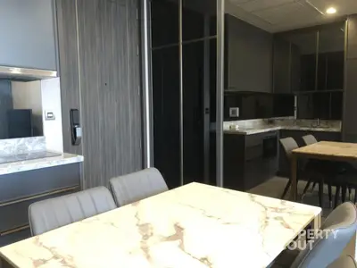 Modern kitchen with sleek marble dining table and contemporary cabinetry