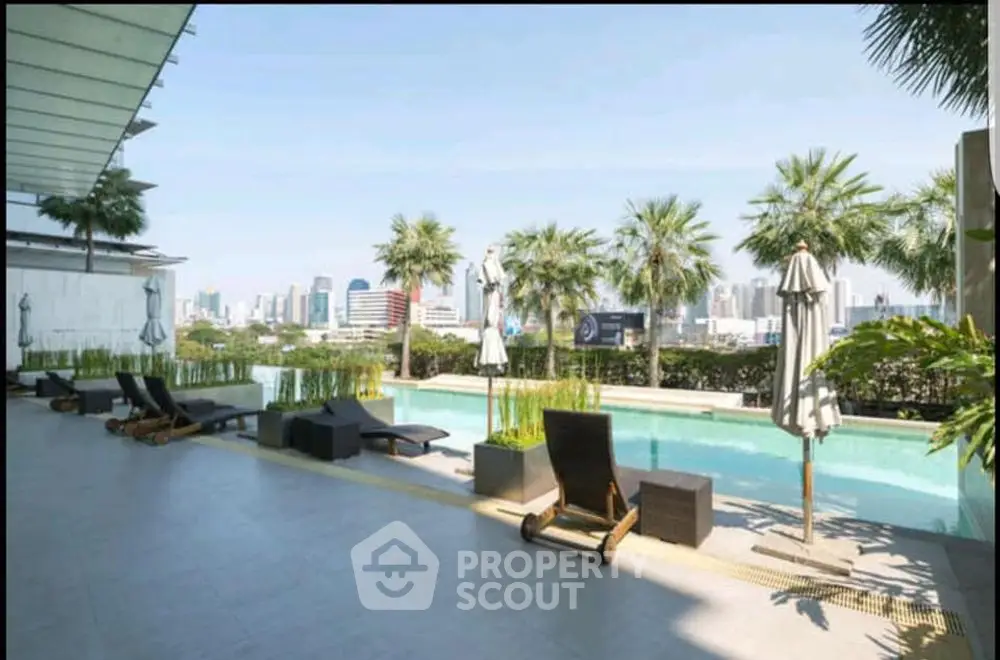 Luxurious rooftop pool with stunning city skyline view and palm trees, perfect for relaxation and leisure.