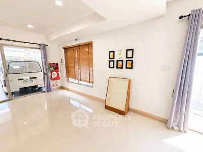 Spacious and bright living room with large windows and modern decor