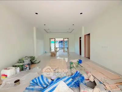 Spacious under-construction living room with modern design and ample natural light.