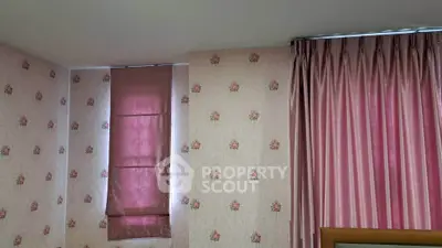 Charming bedroom with floral wallpaper and elegant pink curtains