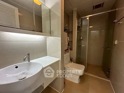 Modern bathroom with sleek fixtures and glass shower enclosure