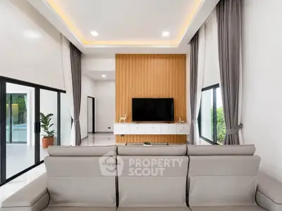 Spacious modern living room with elegant decor and large windows for natural light.