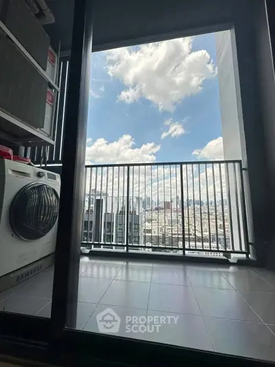 Stunning high-rise balcony with city skyline view and modern laundry appliances.